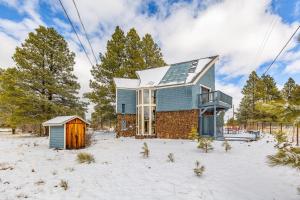 a house in a snowy field with a house at Wild Bill Retreat Treehouse Acre of Fun Near Grand Canyon Williams in Williams
