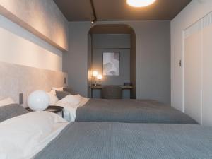 Ένα ή περισσότερα κρεβάτια σε δωμάτιο στο マクノウチイン新大阪駅前1113号室