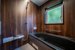 a bathroom with a bath tub and a window at NISEKO Mt,Village - Vacation STAY 65414v in Kaributo +87 photos