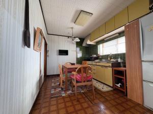 a kitchen with a table and chairs in a room at Kohaku - Vacation STAY 20481 in Nagahama +17 photos
