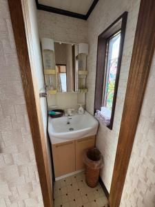 a bathroom with a sink and a mirror at Kohaku - Vacation STAY 20481 in Nagahama