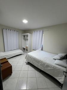 Ένα ή περισσότερα κρεβάτια σε δωμάτιο στο Casa Praça 16 - Porto de Galinhas AFT