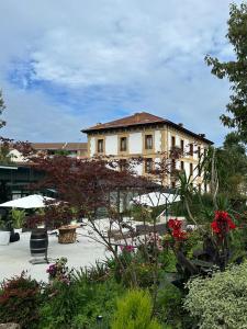a large building in the middle of a garden at Hotel Olajauregi in Durango