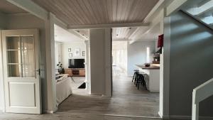 an open hallway with a living room and a kitchen at Winter Wonderland Home in Rovaniemi