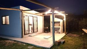 a house with a lit up patio at night at Casa en punta N a 12 minutos de Piriapolis in Punta Colorada +9 photos