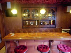 a bar with two red padded stools and a counter at Tawaraya-Traditional Japanese-style Inn - Vacation STAY 73840v in Shimo-tahara