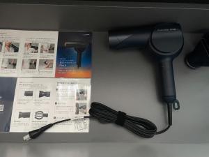 a black blow dryer sitting on a counter next to papers at Tawaraya-Traditional Japanese-style Inn - Vacation STAY 73840v in Shimo-tahara