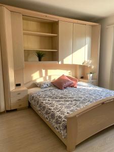 a bedroom with a large bed with a large cabinet at Stay Inn - Meisterschwanden in Meisterschwanden