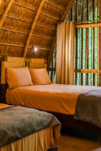 a bedroom with two beds in a room with windows at Casa Lorette in Martínez
