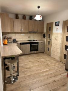 a kitchen with wooden cabinets and a counter top at Chata Chotár Nová Baňa in Veľká Lehota +16 photos