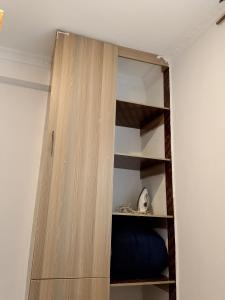 a wooden book shelf in a room at The Pent House Homes in Kisii