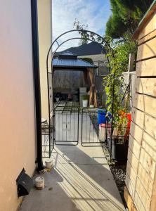 an entrance to a backyard with an iron gate at Excellent Place to Stay in Coquitlam