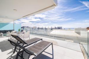 a balcony with a table and chairs on a roof at Med2holidays in Fuengirola
