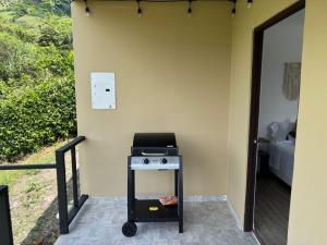 a kitchen with a stove on the side of a wall at Wakana Ecosuits in Apulo +8 photos
