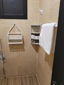a bathroom with a towel rack and a towel at العييري للشقق المخدومة القصيم 1 in Buraydah