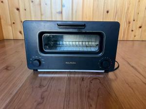 a black toaster oven sitting on a wooden floor at Haraoka House - Vacation STAY 74364v in Haraoka