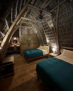 a bedroom with two beds in a bamboo house at Casa Lorette in Martínez +17 photos