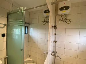 a shower with a glass door in a bathroom at Beam Gate in Uyo +33 photos