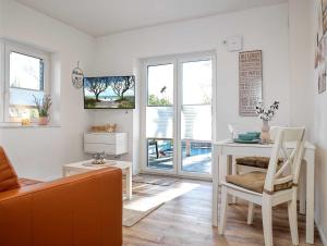 a living room with a couch and a table at Glück Ahoi in Insel Poel