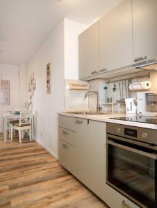 a kitchen with a sink and a stove top oven at Glück Ahoi in Insel Poel +12 photos