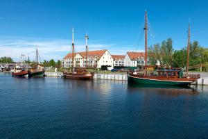 a group of boats docked in a body of water at Glück Ahoi in Insel Poel
