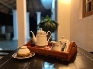 a tray with tea pots and cups on a table at Elegance Cottage in Dagonna