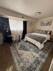 a bedroom with a bed and a desk and a rug at Cozy and well located 2-bedroom basement in Provo