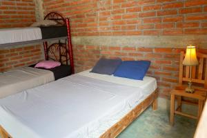 Postel nebo postele na pokoji v ubytování Wajakita Experience Hostel