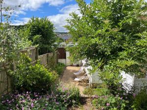 a garden with a bench and some flowers at Bungalow on Dartmoor's Edge, Parking & Garden in Ashburton