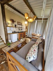 a living room with a couch and a table at Chalé Girassol - Vila Monte Cunha in Cunha