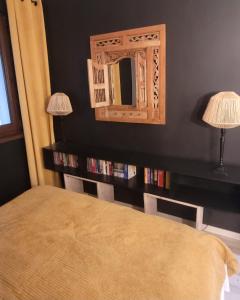 a bedroom with a bed and a mirror on the wall at Apartament Szpilka - domek in Police