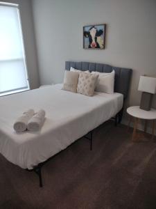 a large bed with two pairs of shoes on it at Onsite coffee bar just mins to Jack Thrice Stadium in Ames