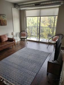 a living room with a large window and a rug at Onsite coffee bar just mins to Jack Thrice Stadium in Ames