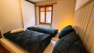 Ένα ή περισσότερα κρεβάτια σε δωμάτιο στο Apartment Dita - Cozy Stay in Kandersteg