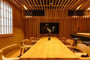 ein Konferenzraum mit einem Holztisch und Stühlen in der Unterkunft Jinglan [Orchid Residence] - Vacation STAY 80077v in Kyōto