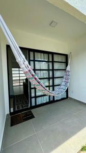 a hammock in a room with a large window at Refúgio Amazônico com Piscina e Natureza in Manaus