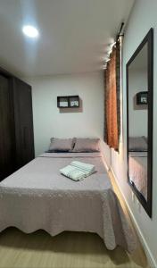 a bedroom with a large bed with a mirror at Refúgio Amazônico com Piscina e Natureza in Manaus +34 photos