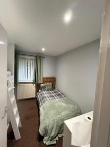 a small bedroom with a bed and a window at 100 Castle in New Cumnock