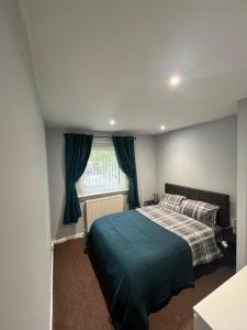 a bedroom with a bed and a window at 100 Castle in New Cumnock