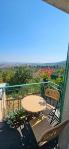 a balcony with a table and chairs and flowers at Letto del Monte guest house in Lettomanoppello