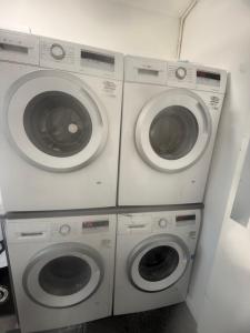 three washing machines are stacked next to each other at Modern Studio - Centre Maidstone in Maidstone +1 photo