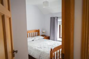 a bedroom with a bed and a window at Jack's House in Glenties
