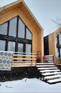 a building with a group of benches in the snow at 4 Chalet near Borjomi in Borjomi