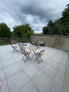 a group of chairs and tables on a patio at Superbe Appartement en Duplex - 4/6 Pers - 1er Etage - Blainville sur l'Eau in Blainville-sur-lʼEau