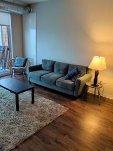 a living room with a couch and a table at 4 mi to Jack Thrice Stadium + amenities in Ames