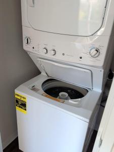 a washer and dryer sitting on top of a refrigerator at 4 mi to Jack Thrice Stadium + amenities in Ames