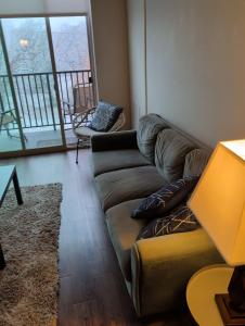 a living room with a couch and a large window at 4 mi to Jack Thrice Stadium + amenities in Ames +20 photos