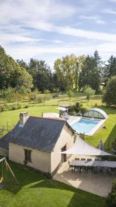 an overhead view of a house with a swimming pool at Le Grand Launay in Pacé