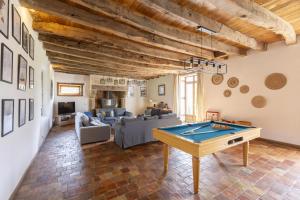 a living room with a pool table in it at Le Grand Launay in Pacé