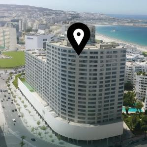 a tall building with a location sign on top of it at Modern Elegance Luxury Living City Center in Tangier